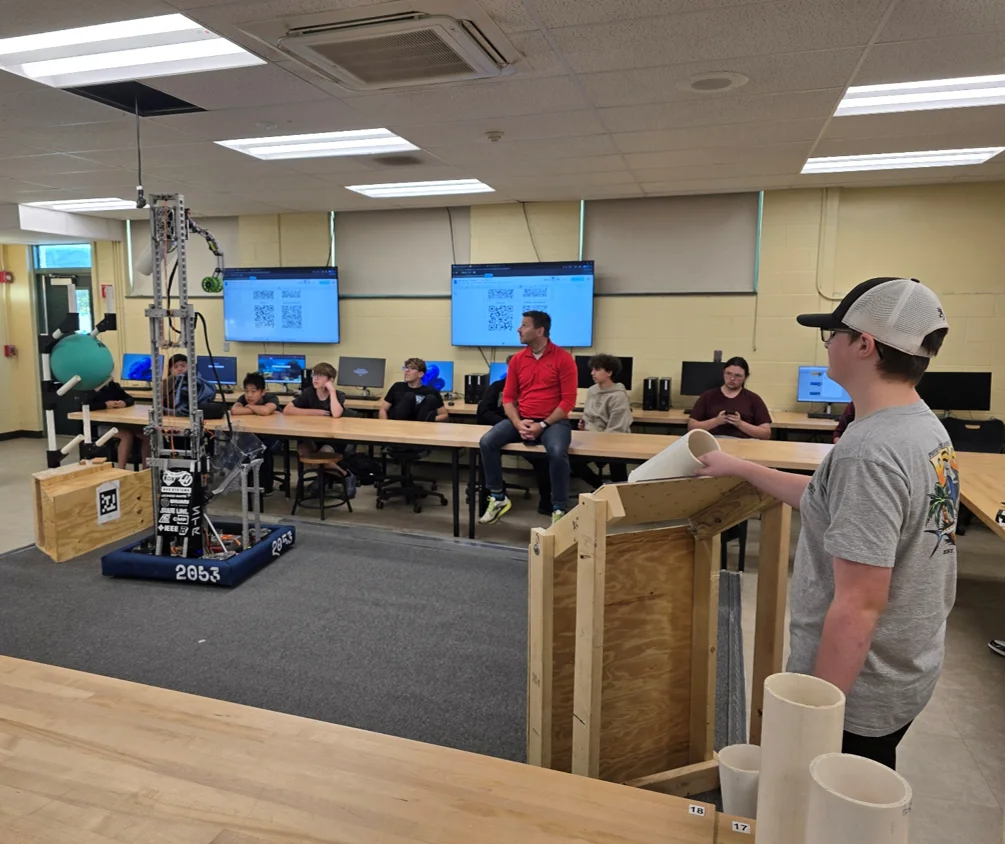 Demonstrating our Reefscape robot to prospective new members