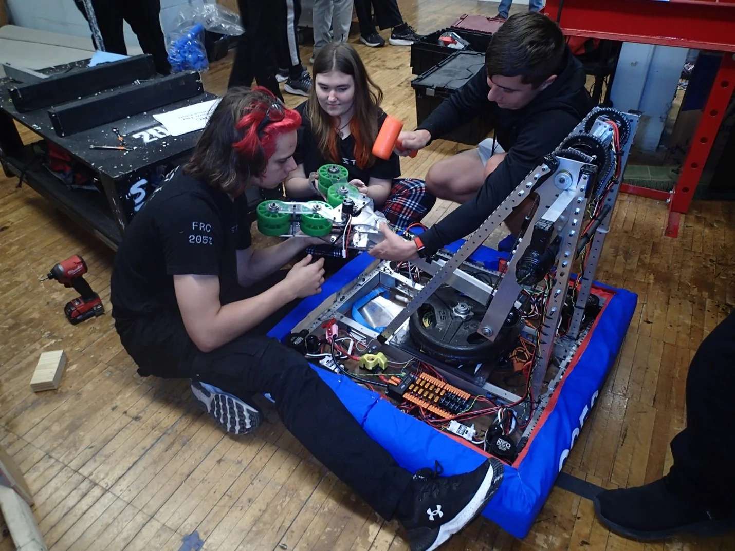 Students working on the robot in the shop