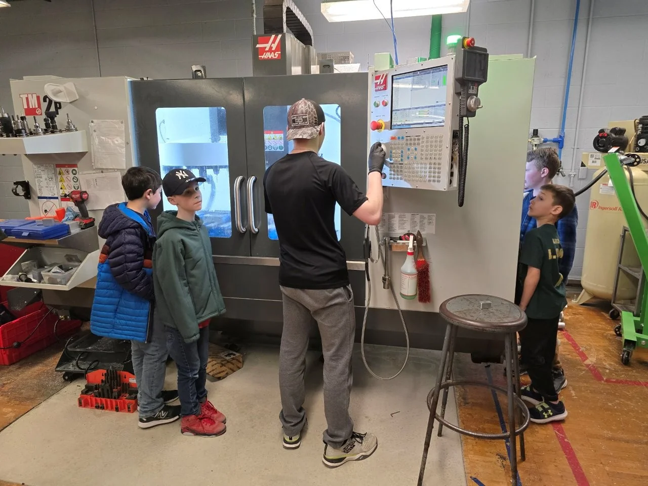 Demonstrating CNC lathe operation